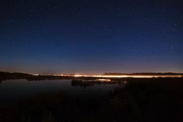 Foto op Plexiglas The stars in the night sky reflected in the river.  © lexuss