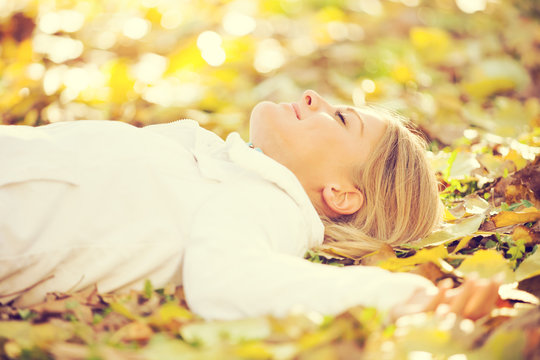 Young happy woman relaxing in park, intentionally toned.