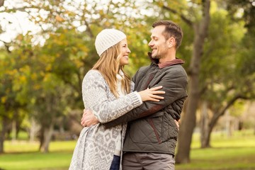 Fototapeta premium Portrait of smiling young couple embracing