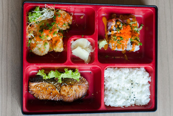 bento box with roll and salmon