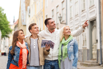 group of friends with city guide exploring town