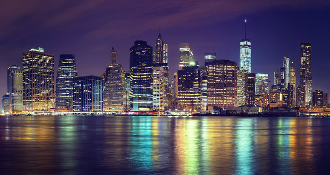 Vintage toned Manhattan skyline at night, NYC, USA.