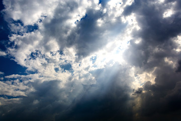 rain cloud and sun beam with dark sky