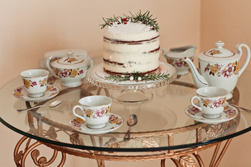 Young beautiful blond woman in winter dress making cake with cre