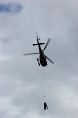 Menschen werden mittels Taubergung (Seilbergung) von einem Hubschrauber gerettet
