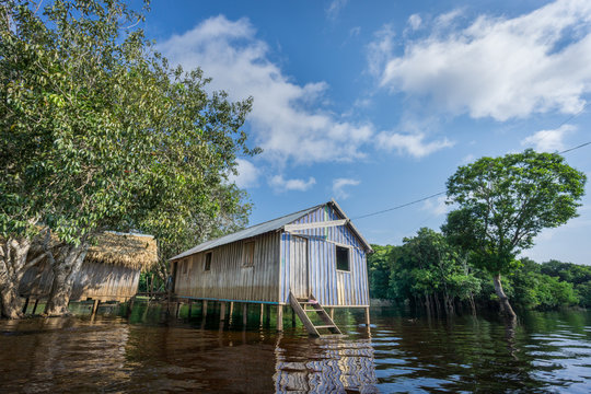 Woode houses built on high stilts over water, Amazon rainforest