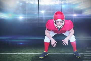 Composite image of american football player in attack stance