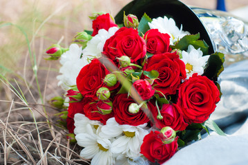wedding bouquet of red roses in the champagne bucket