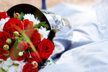 wedding bouquet of red roses in the champagne bucket