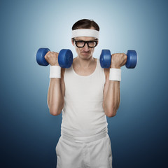 Funny sport nerd lifting weights isolated on blue background