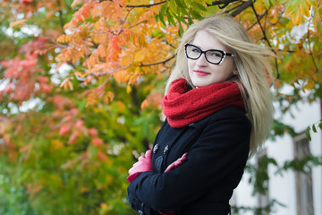 Blonde young woman with waving hair wearing cat eye glasses