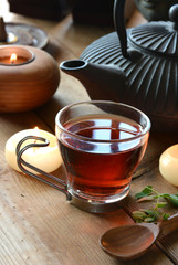 cups of black tea accompanied by incense