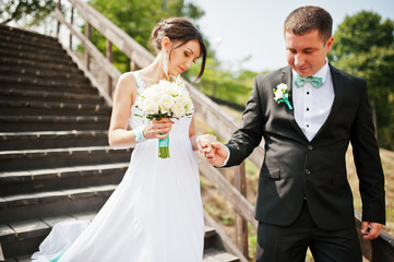 wedding couple on wooden stairs
