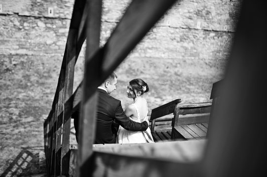 wedding couple on wooden stairs