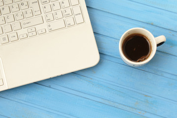 White lap top computer and black coffee