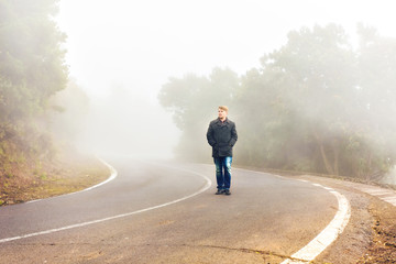 Man walking in a misty forest