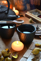 Obraz na płótnie Canvas cups of black tea accompanied by incense