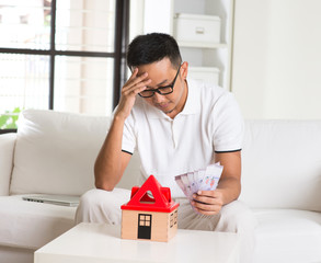 asian man stress on high property price and debts