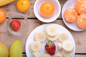 Fresh colorful fruits composition mandarin, strawberry, peach, bananas and orange