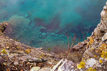 Wheel at the bottom of a flooded quarry Azure, near Nizhny Tagil, autumn