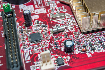 red computer motherboard with electrical components