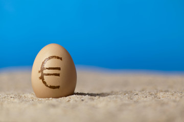 Universal money icon painted on eggs on the sand