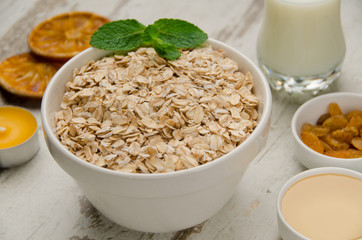 Oatmeal with honey , raisins, mint and orange slice