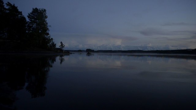 Gentle waves during a sunset over a lake in Sweden during summer.