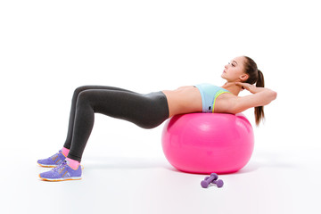 Fototapeta premium Sports woman doing exercises on fitness ball