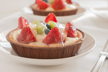 Fruit tarts filled with Strawberries Kiwi Fruit and Blueberries