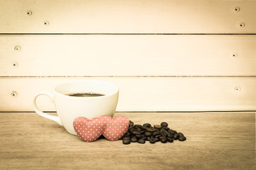 cup of coffee and coffee seed with two red heart ,vintage tone