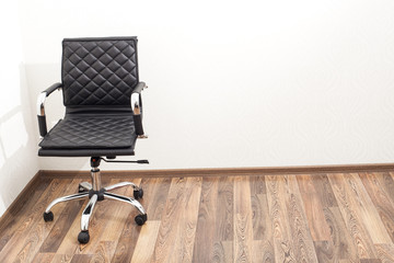 Black leather armchair in office room