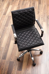 Black leather armchair in office room