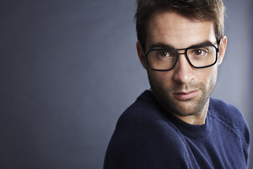 Thoughtful man in glasses, close up