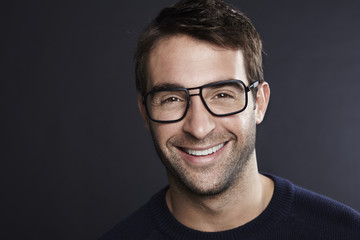 Fototapeta premium Confident man in spectacles smiling at camera