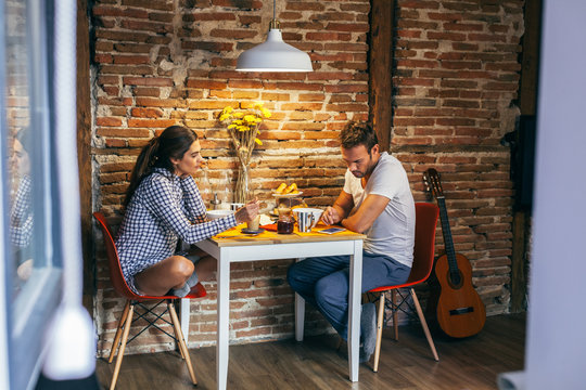 Young Couple Having Breakfast in a Rustic Apartment