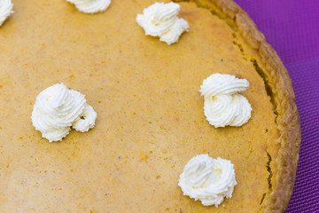 Sweet pumpkin pie with cream close up