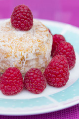 Glazed doughnut with raspberry close up