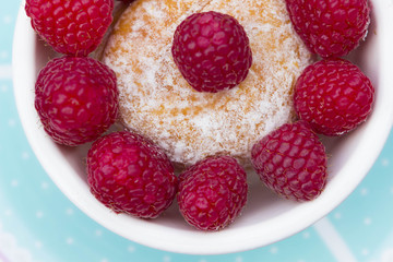 Glazed doughnut with raspberry close up