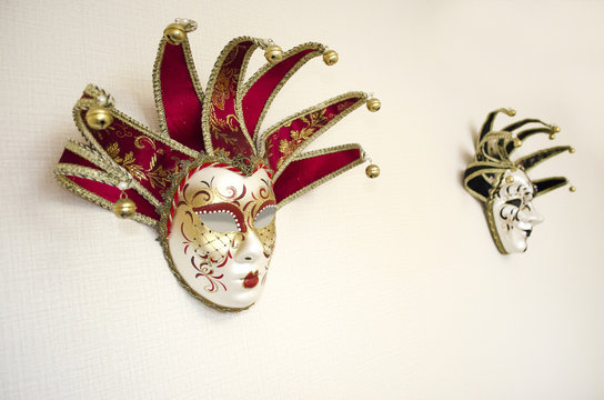 Masquerade masks hanging on white wall. Theater and opera. Carnival mask for Venetian festival. 