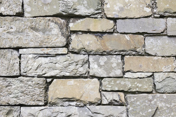 Full frame background or texture of a stone wall constructed from slate in the English Lake District.