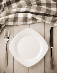 kitchen utensils and cloth napkin on wood