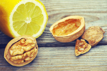 Lemon and walnut on a wooden surface close up
