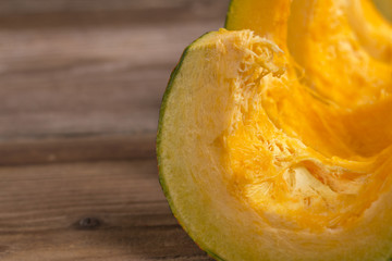 Pumpkins slices on wooden background