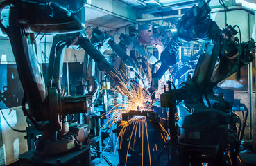 Team welding Robot movement Industrial automotive part in factory