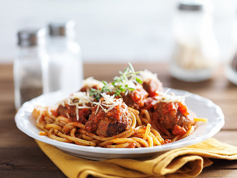 Spaghetti And Meatballs With Oregano Garnish On Rustic Table Shot With Selective Focus