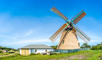 Beautiful and traditional thatched windmill in german north sea village