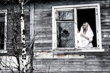 Woman staying near the broken window