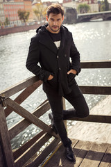 Young model in black coat