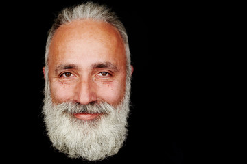 smiley bearded man over black background